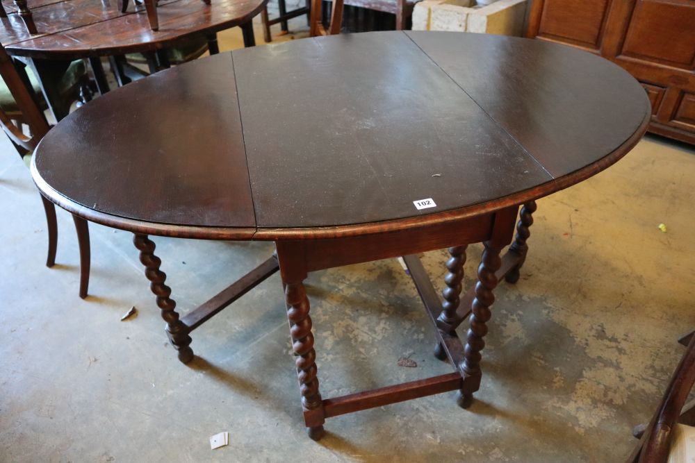 A 1920s oak gateleg table, with spiral twist underframe, width 91cm